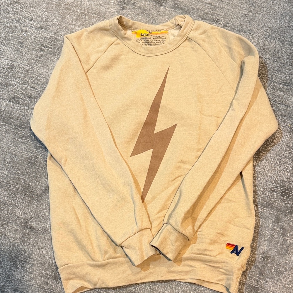 Aviator Nation crew neck sweatshirt. Tan with chocolate brown lightning bolt.